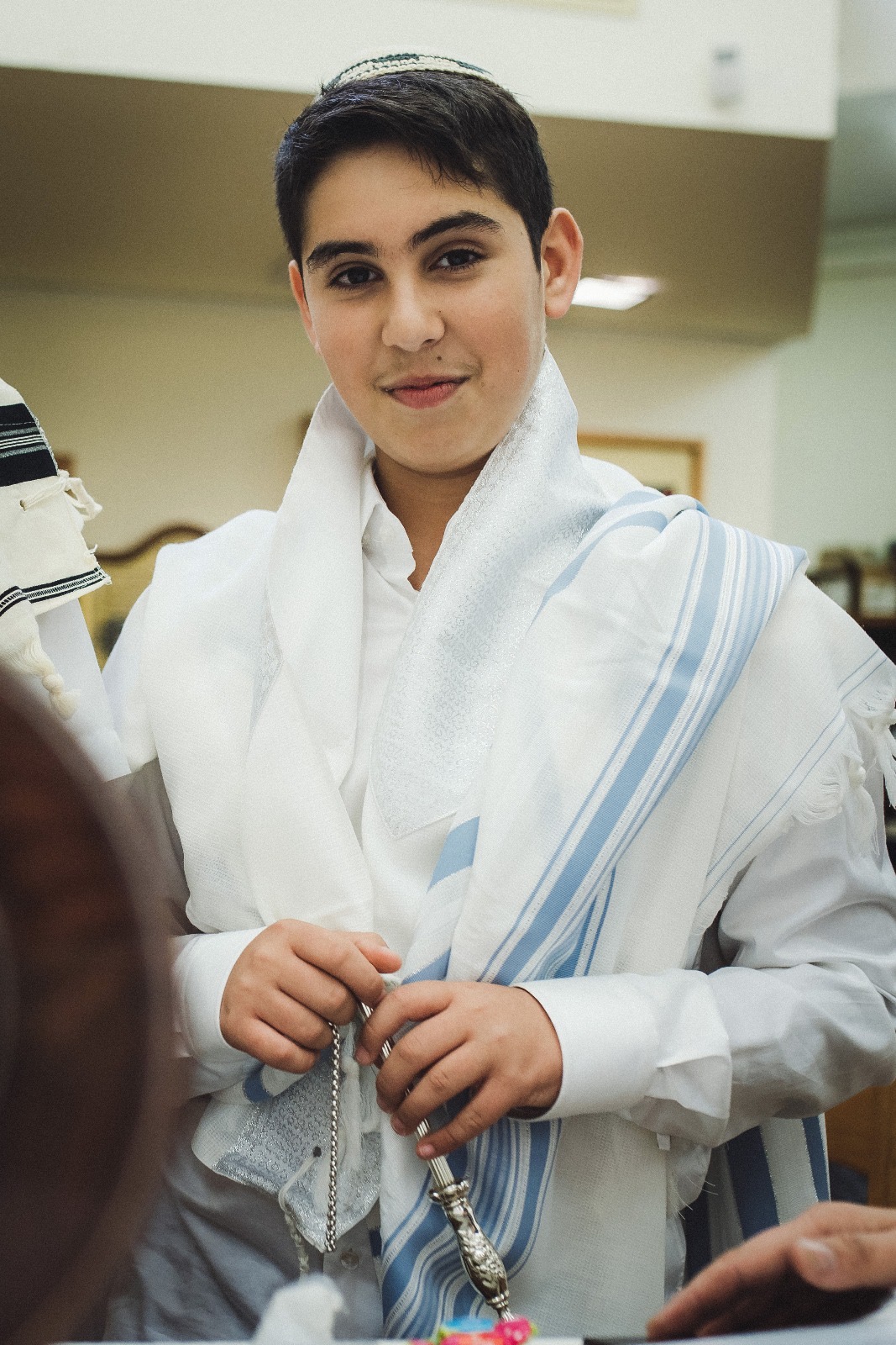 חתן בר מצווה עם טלית בבית הכנסת